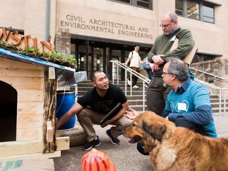 Texas CAE engineering students standing in front of sustainable doghouse design