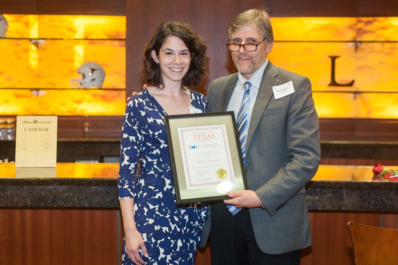 Department chair Richard Corsi and associate professor Maria Juenger holding award at 2013 awards banquet