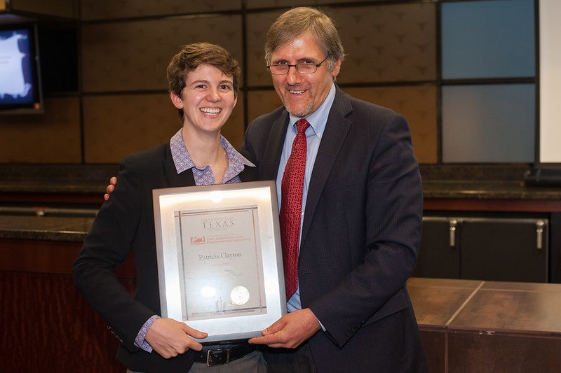 Department chair Richard Corsi and assistant professor Patricia Clayton holding award