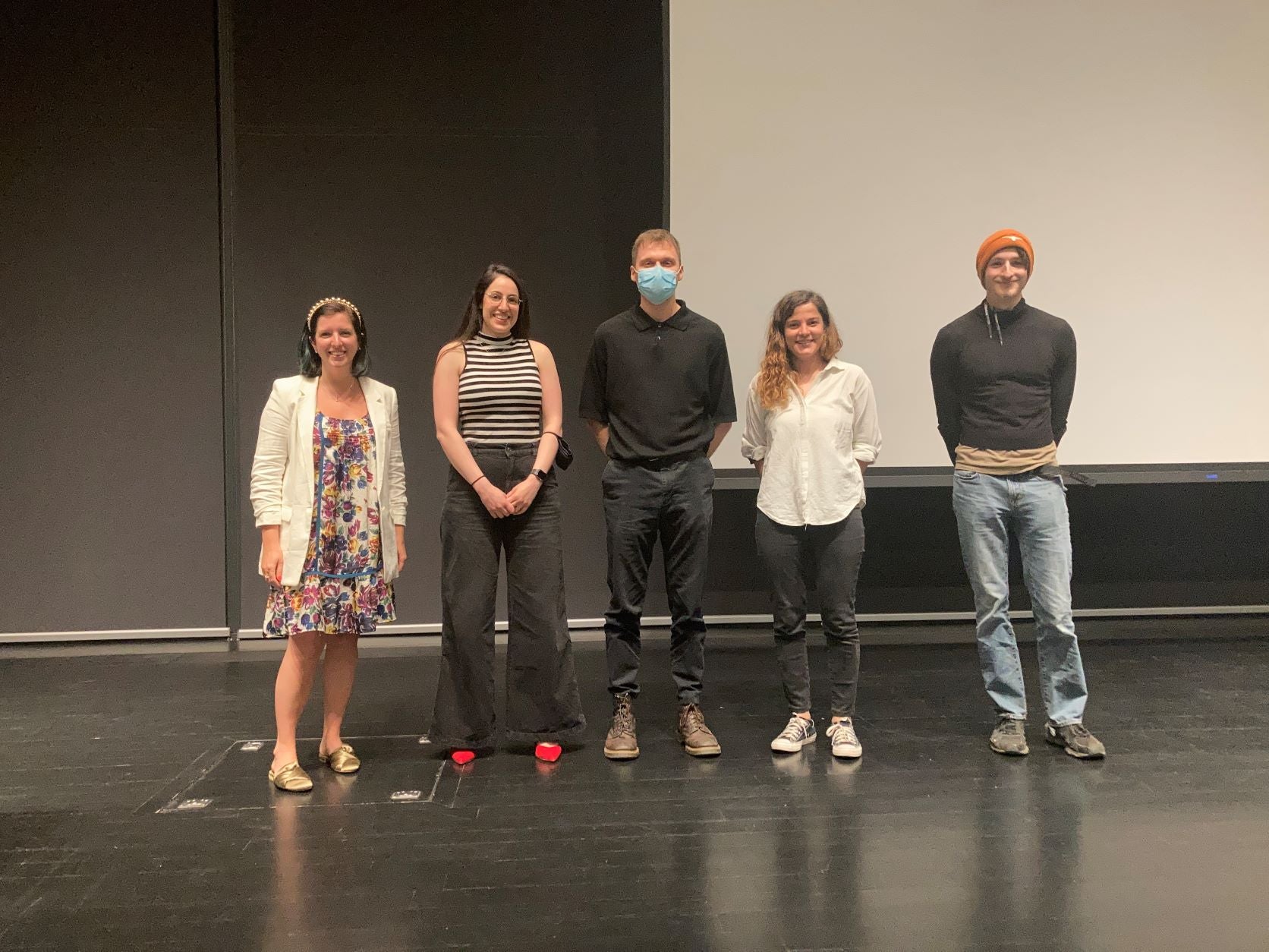 Assistant professor Blair Johnson and CAEE students standing onstage together