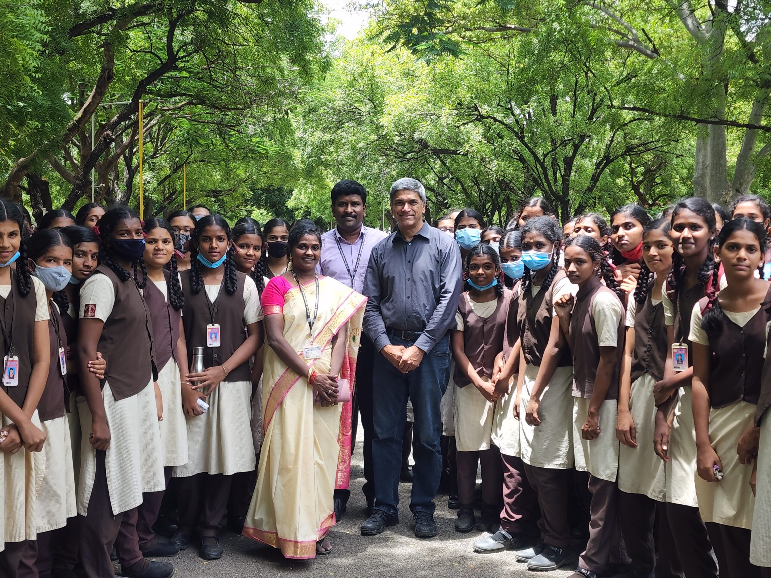 Texas Engineer Lance Manuel smiling with large group of students