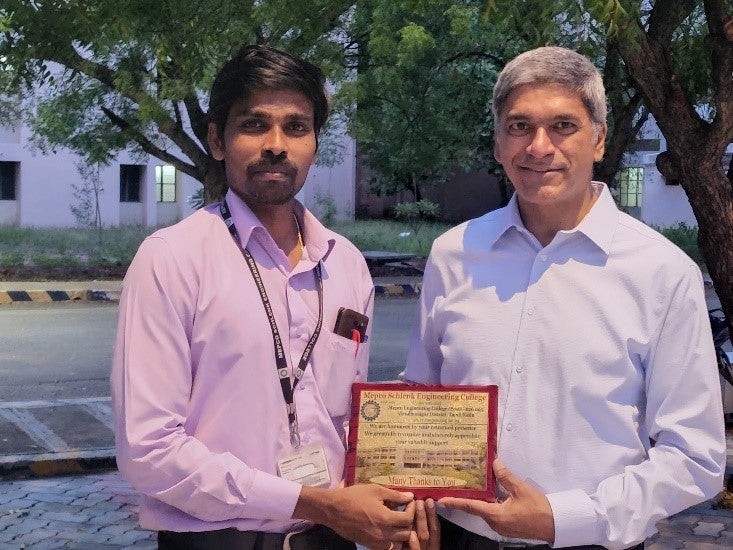 Texas Engineer Lance Manuel holding a certificate with student