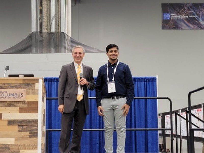 Texas CAEE student Animesh Rastogi standing on stage
