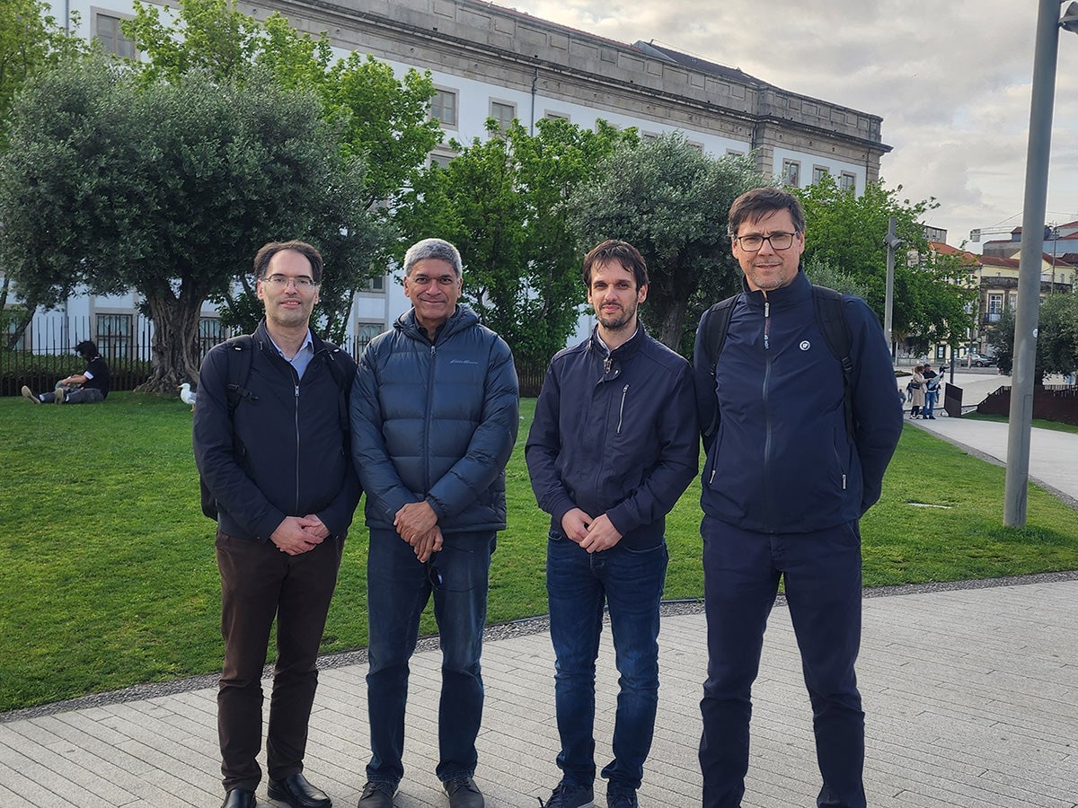 Texas CAEE professor Lance Manuel standing outside with professors José Correia, Cláudio Horas and Abílio de Jesus