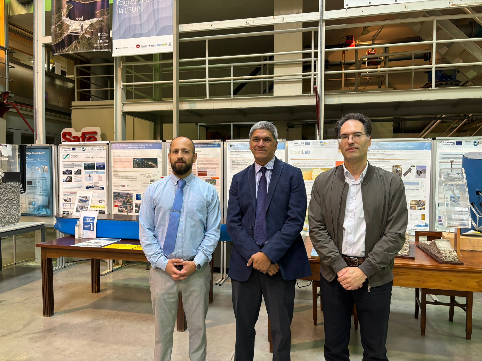 Texas CAEE professor Lance Manuel, Tiago Ferradosa and Professor José Correia standing in front of poster table