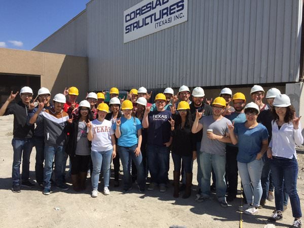 Texas CAEE students at Industry field trip smiling in hard hats