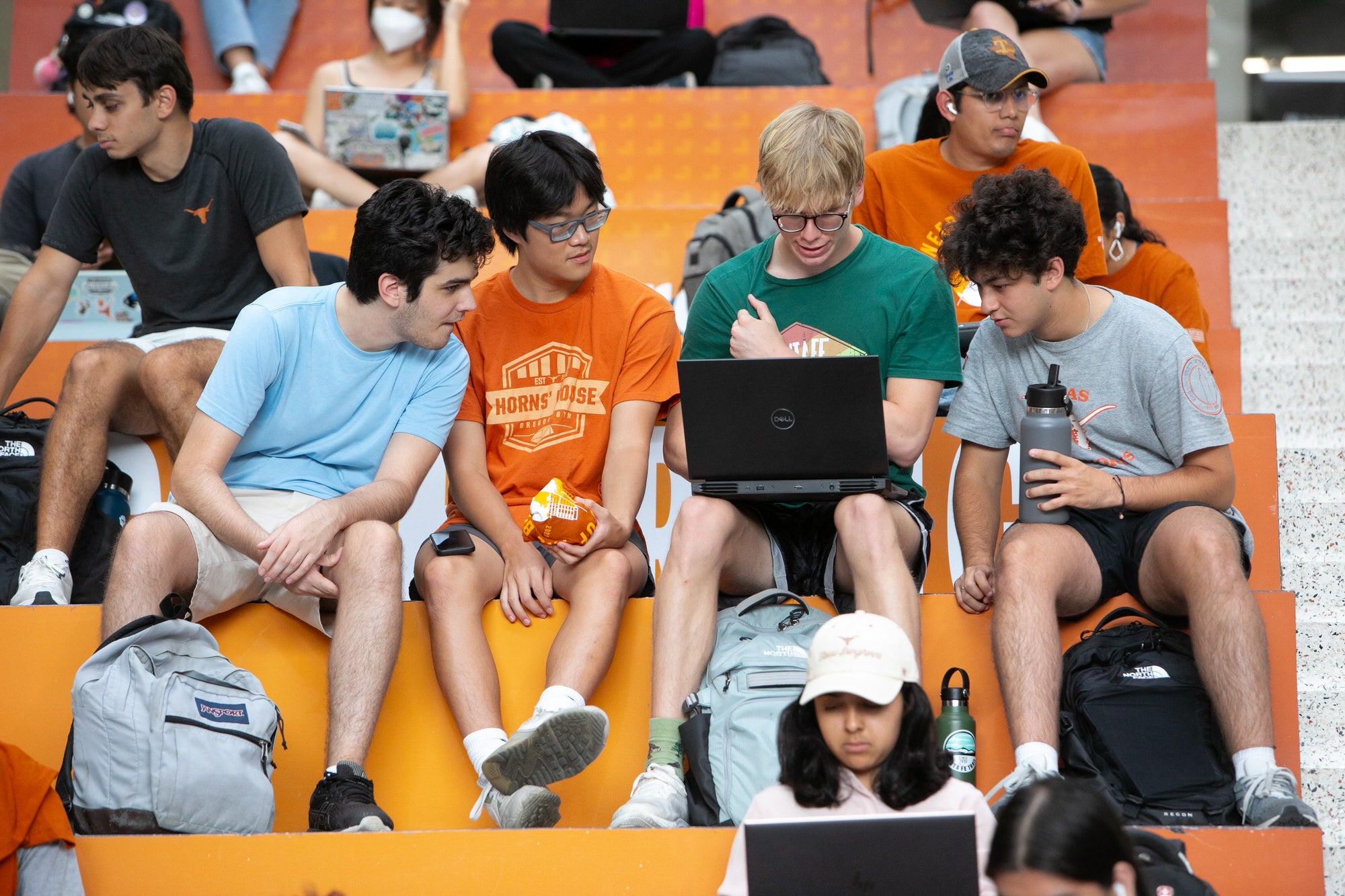 Texas CAEE students working as a group on laptop during the Fariborz Maseeh department naming event.
