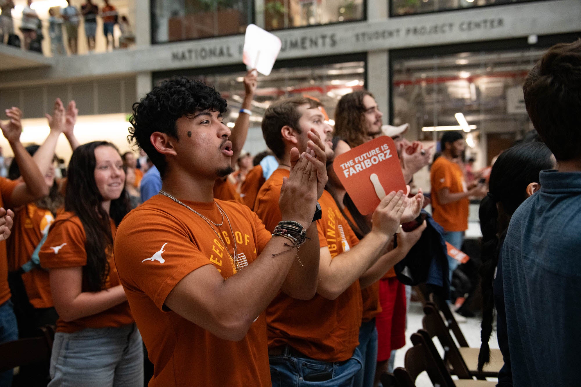 Students and faculty cheering at the Fariborz Masseeh Naming event