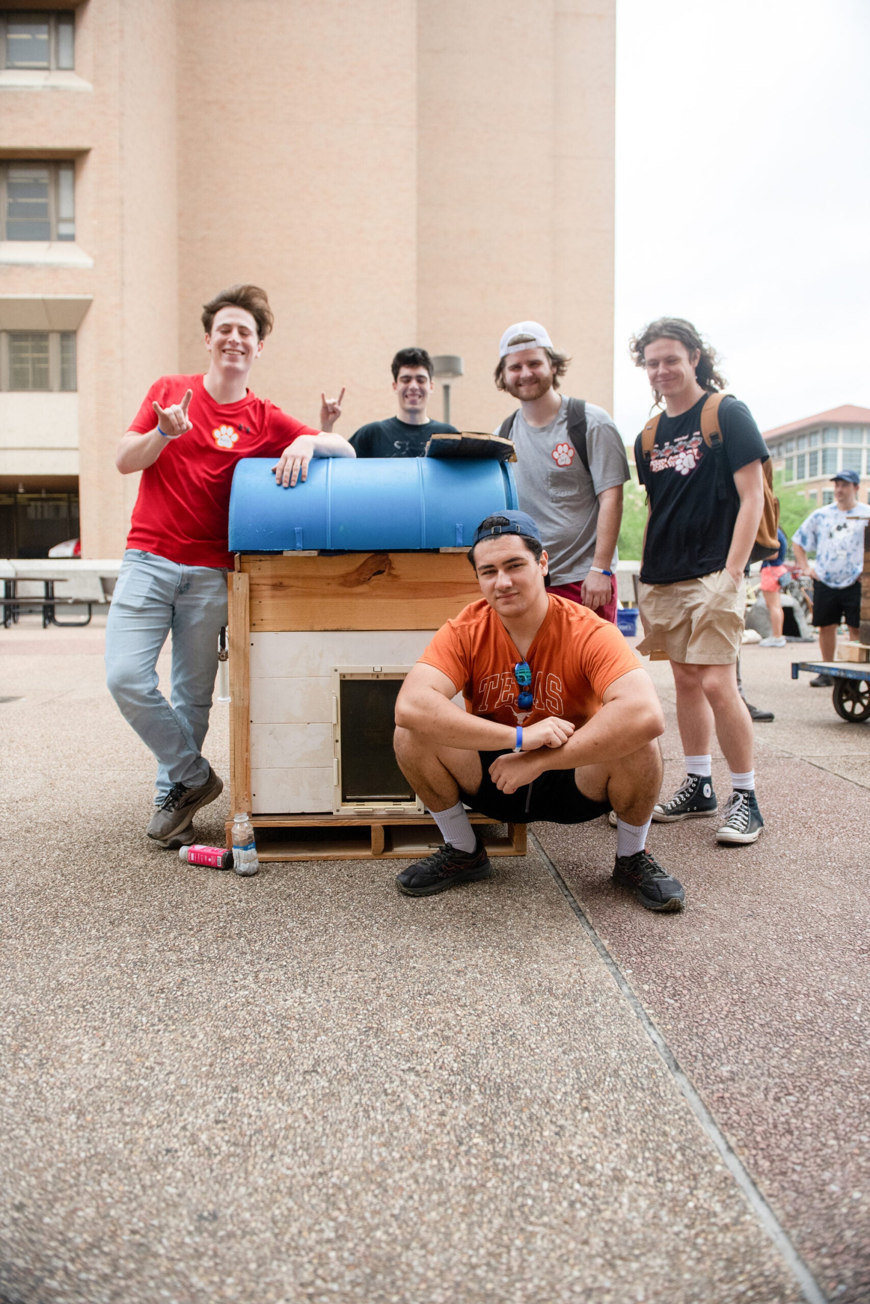 Texas CAEE student pose in front of sustainable doghouse
