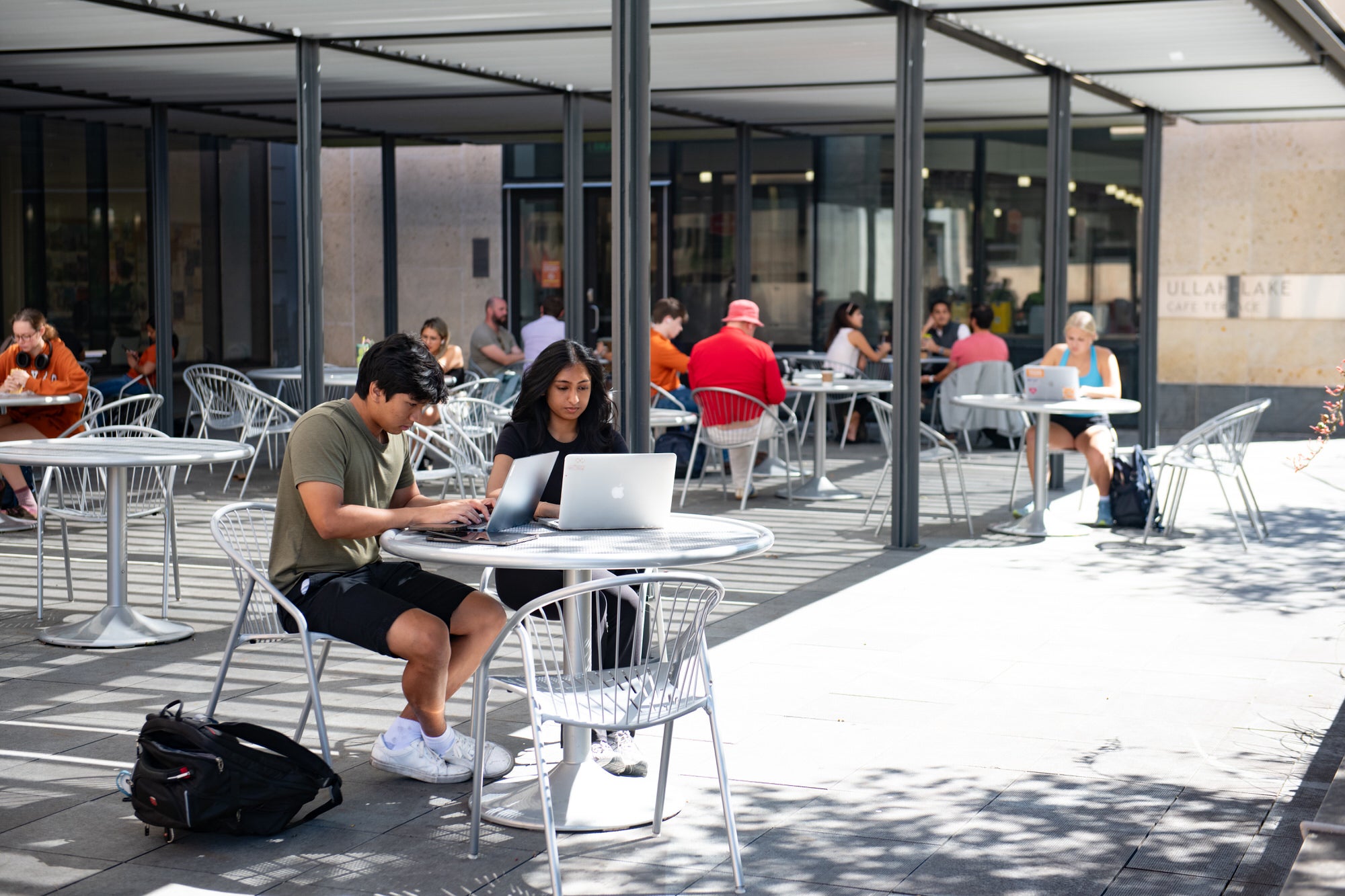 Students on laptops at the patio of O's