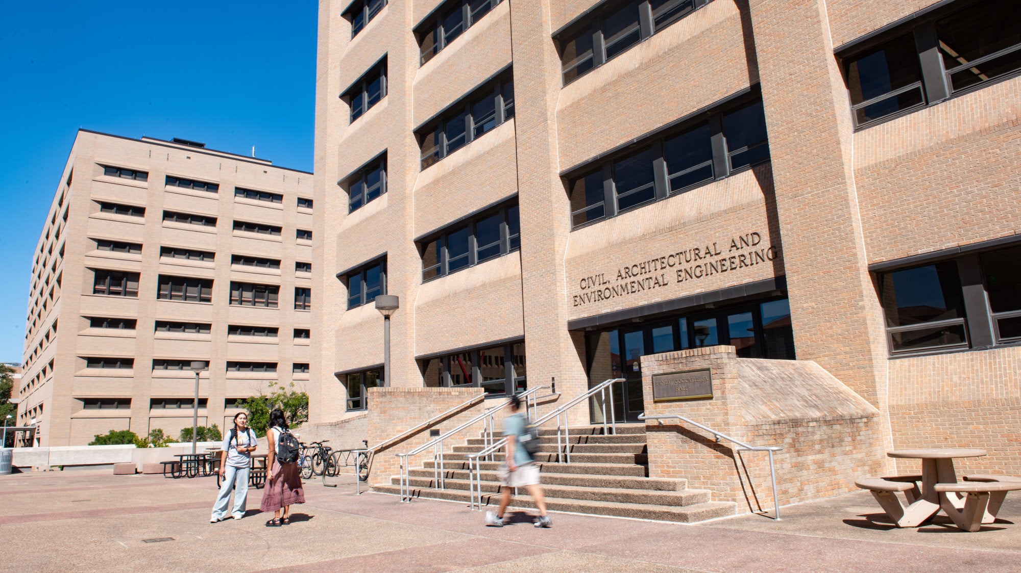 Entrance to CAEE home the ECJ building where students are walking in and out.