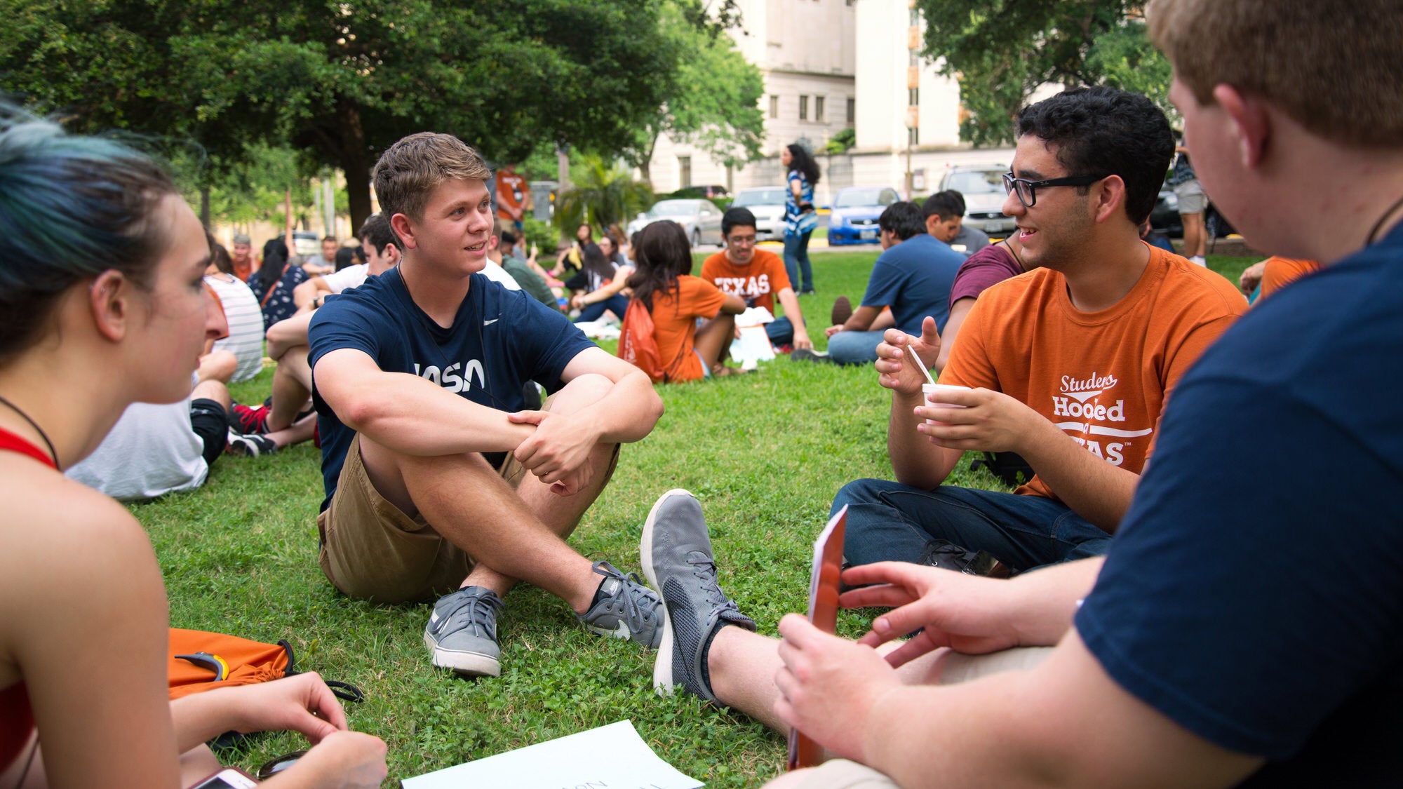 Students talking around the campus lawns.