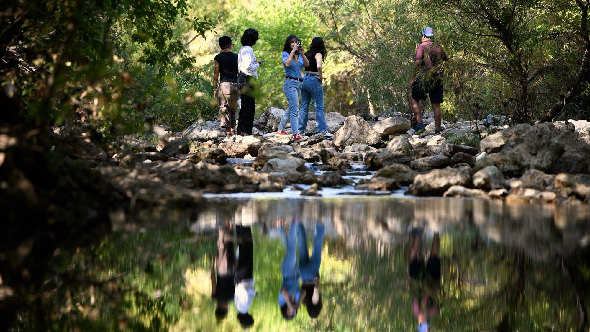 CAEE students in field during water test research lab.