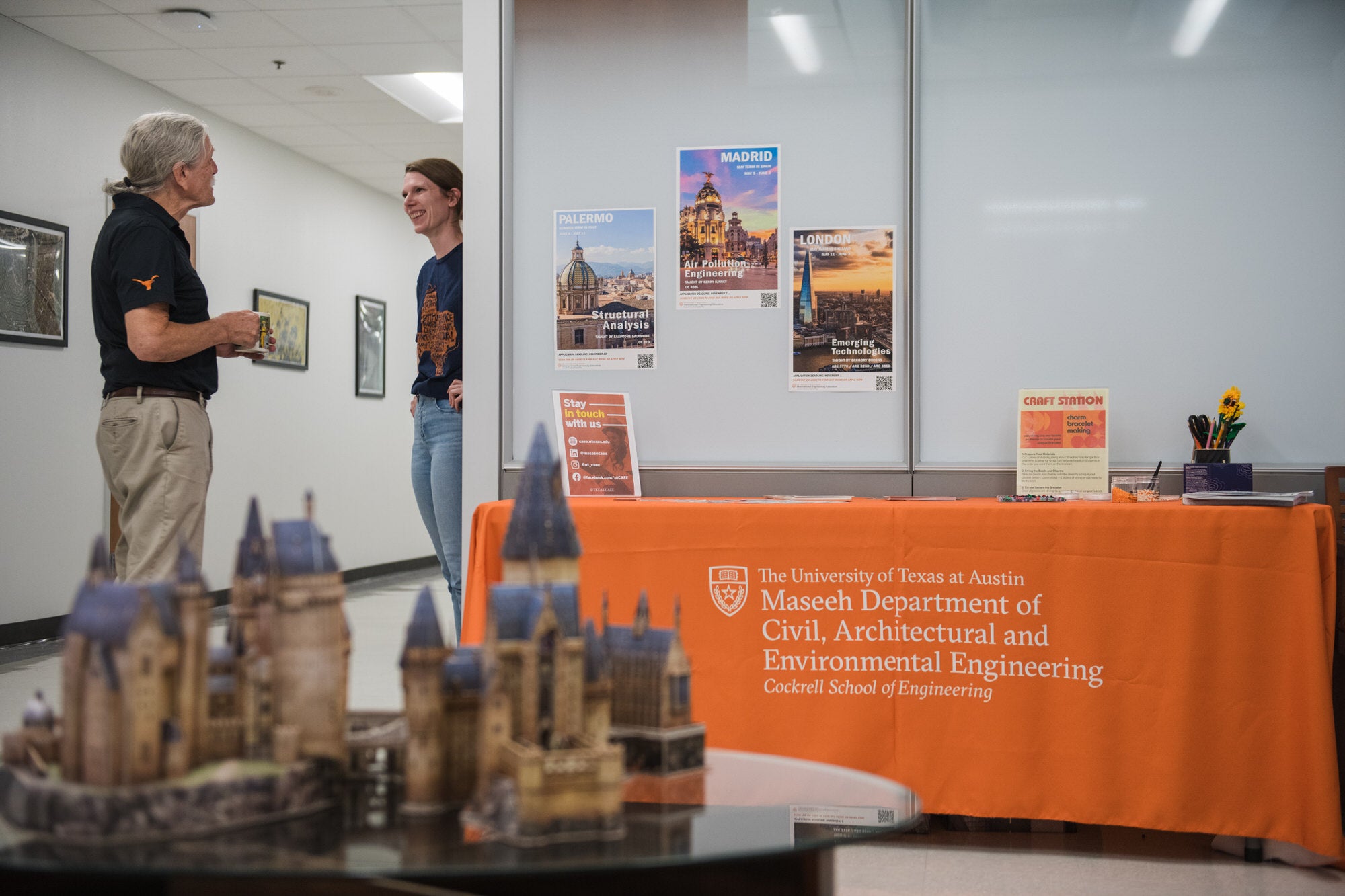 Faculty & staff talking in the CAEE reception area.