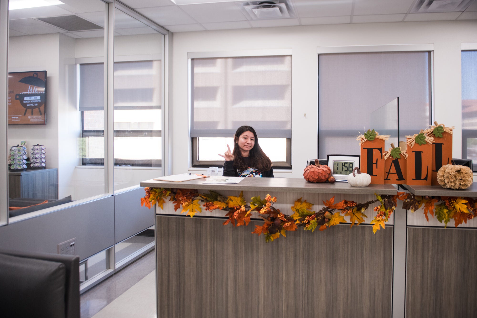 Student worker at CAEE reception desk.