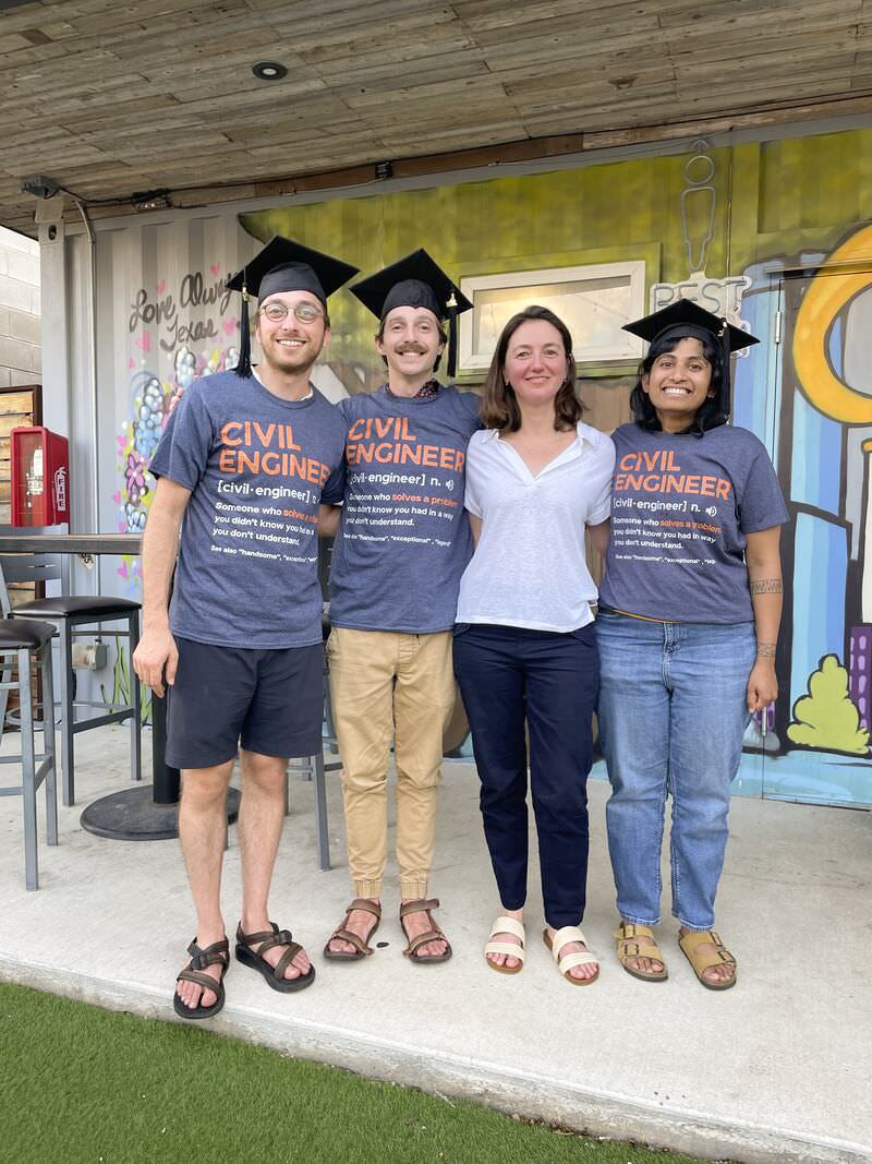 Texas CAEE faculty member stands with students in Civil Engineering tshirts
