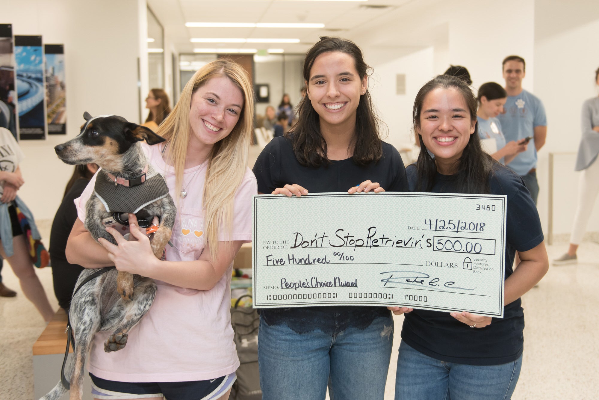 Winners of the Sustainable Doghouse Challenge holding dog.
