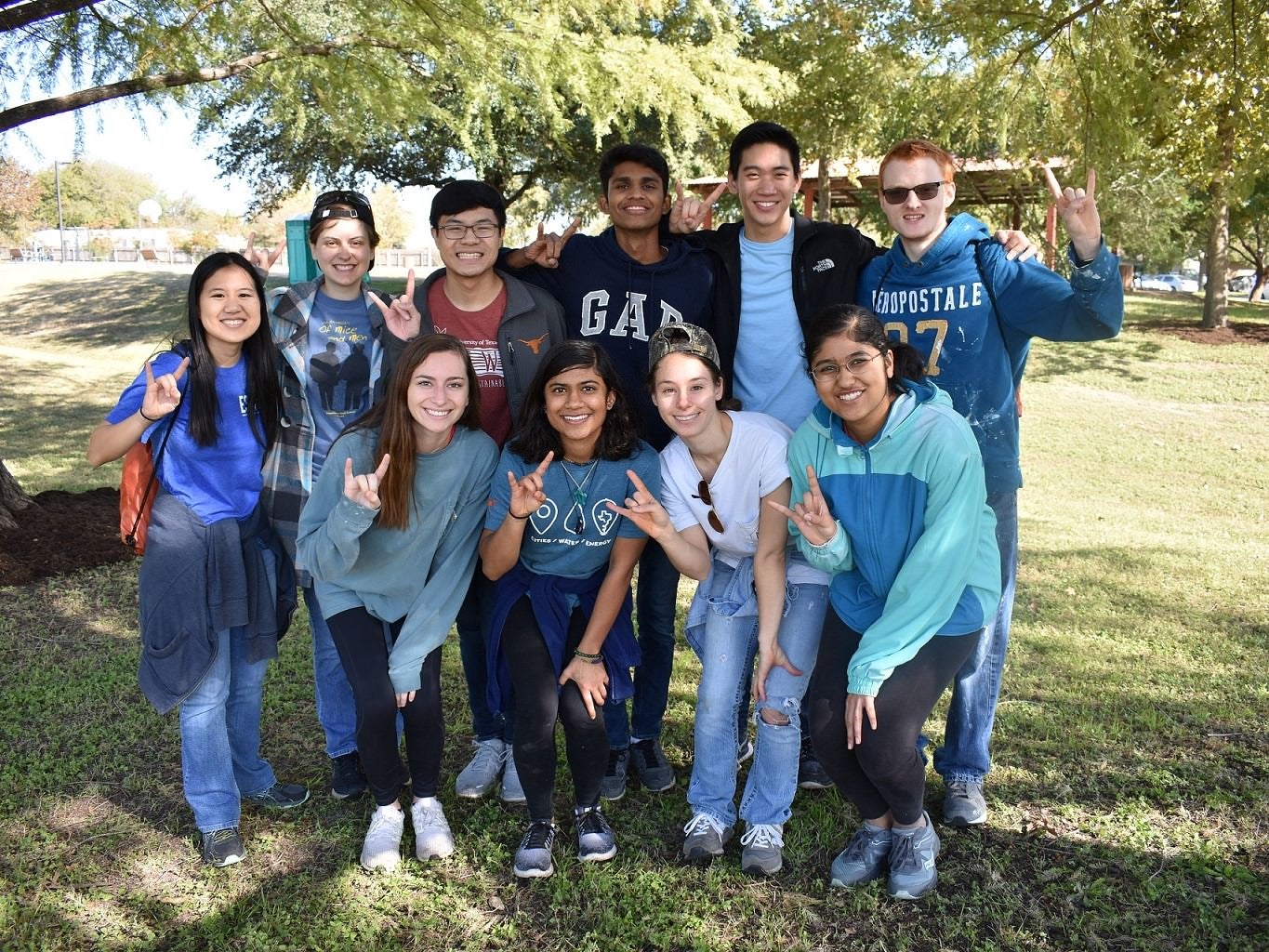 Texas CAEE students pose with hook ems out for the camera