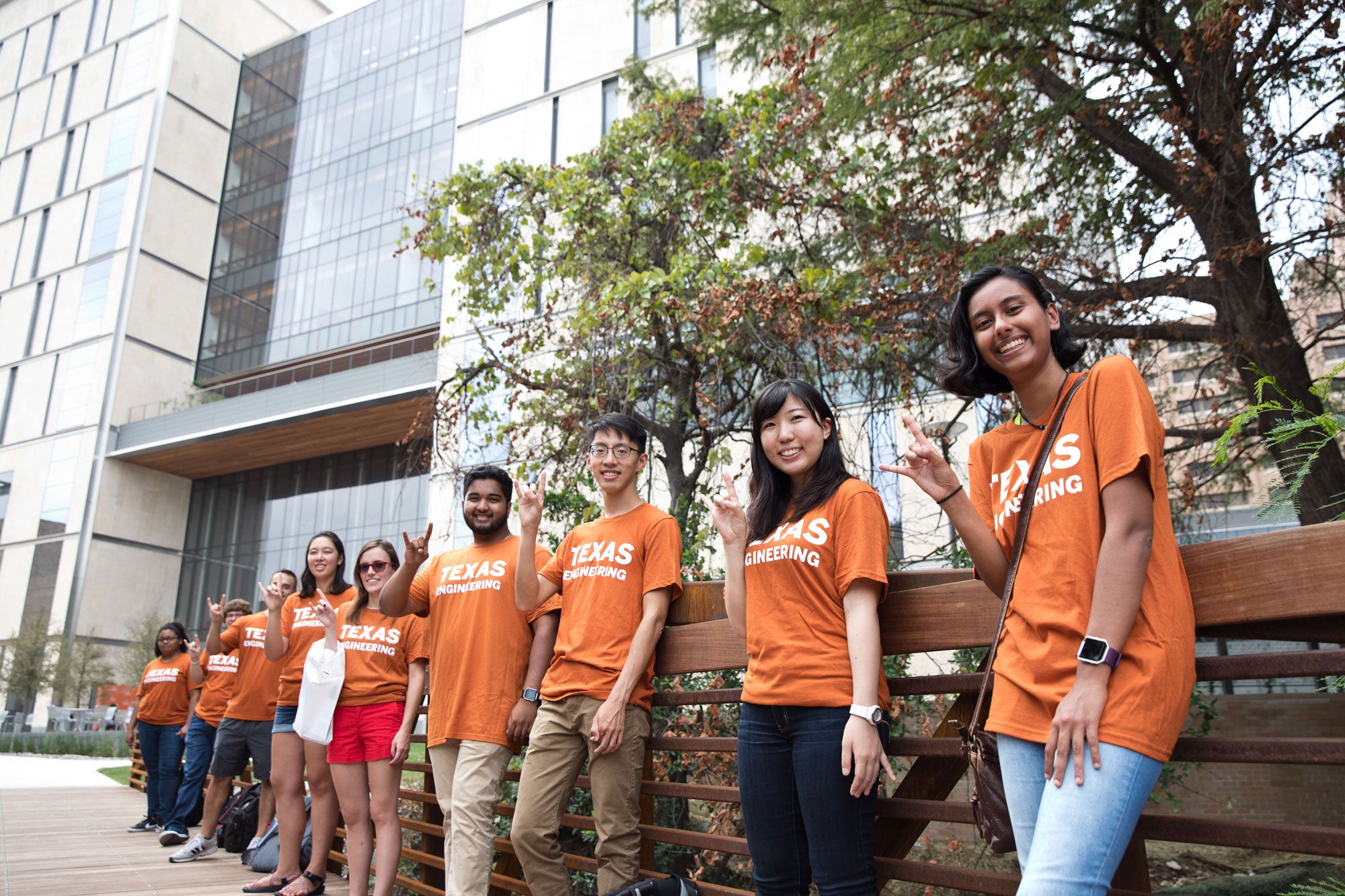 several students standing outside of EER at UT Austin wearing engineering t-shirts