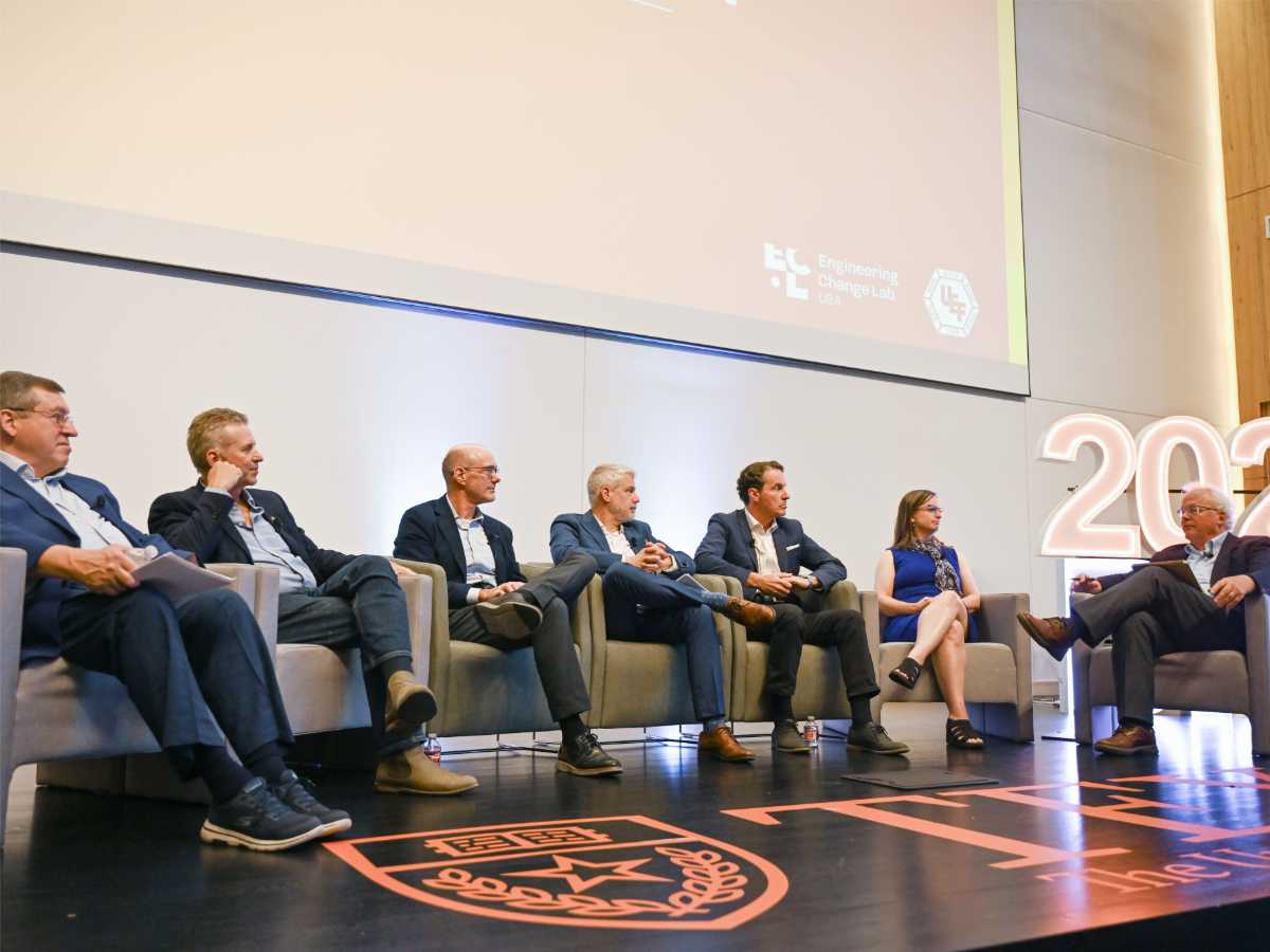 Group of people sitting onstage for panel at 2026 Disruptive Innovation Summit event.