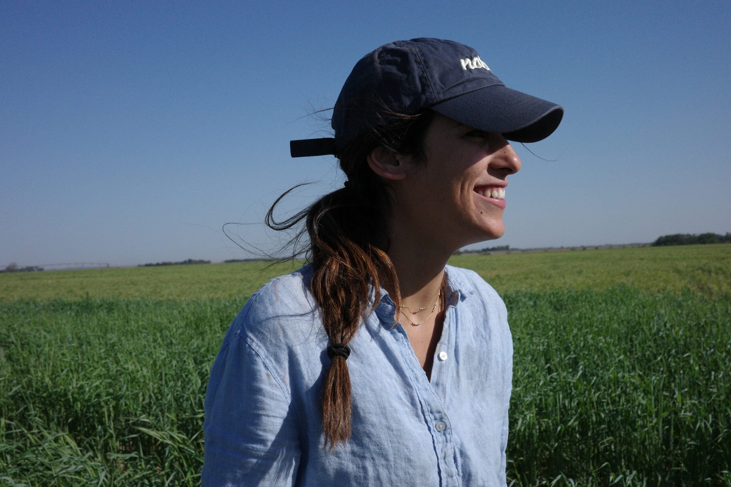 CAEE alumna Magi Richani smiling in a field