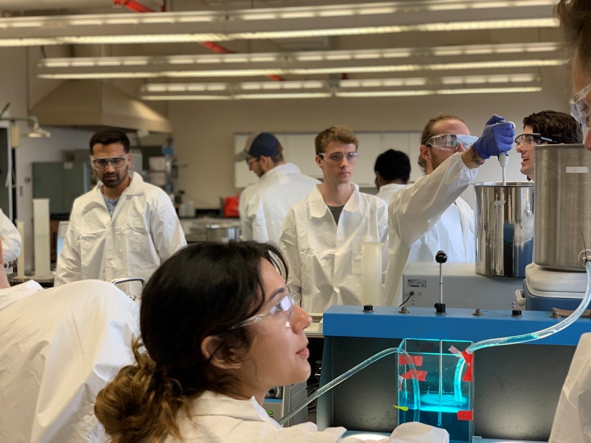 group in lab coats working in lab