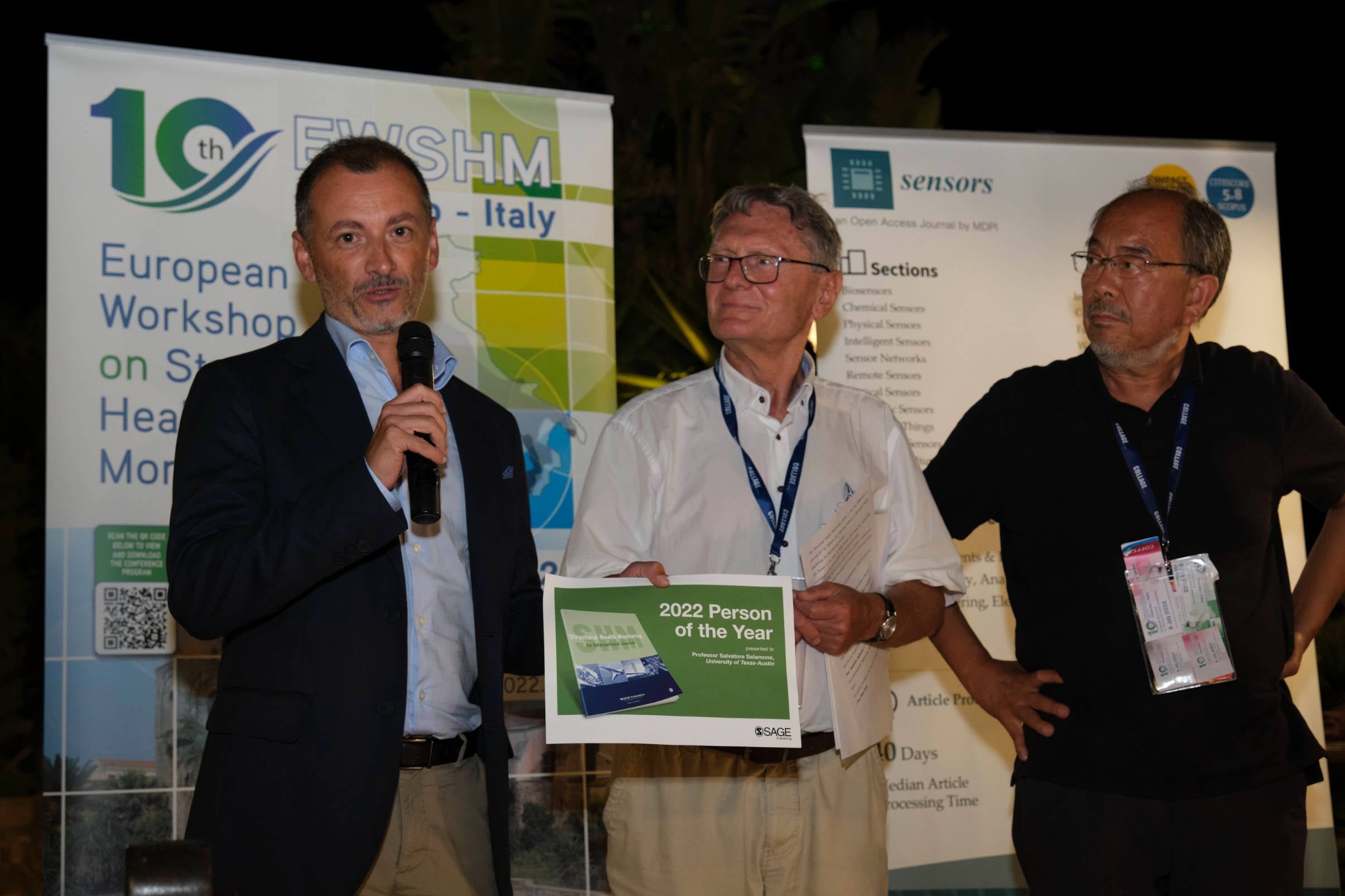 Texas Engineer Salvatore Salamone giving a speech onstage while holding an award