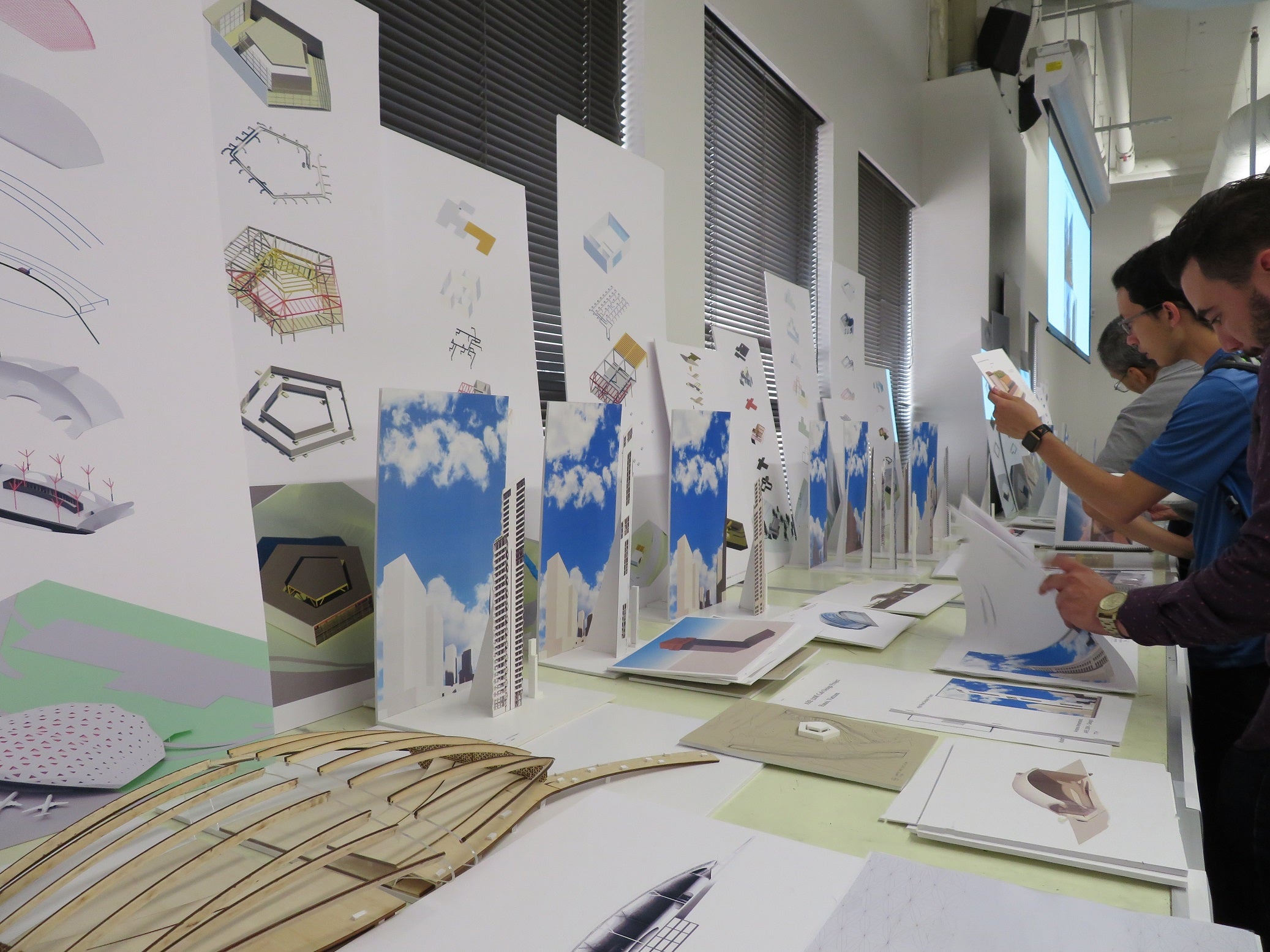 students in front of architectural drawings