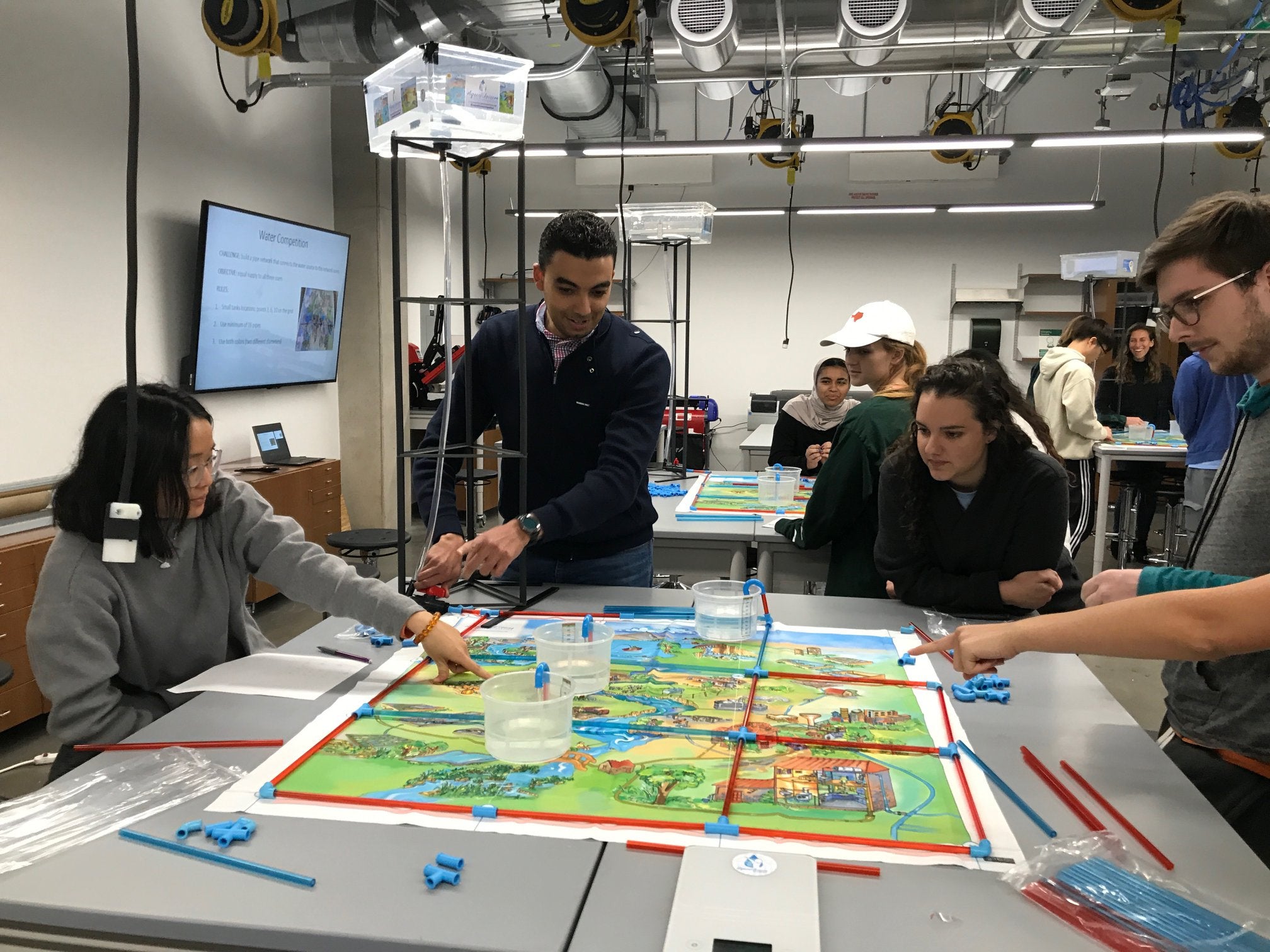 Students around a table pointing at map